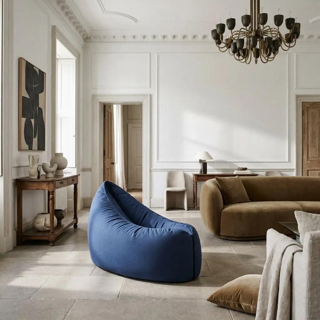 Cream-colored teddy beanbag chair in a bright, elegant living room with stone floors and neutral decor.