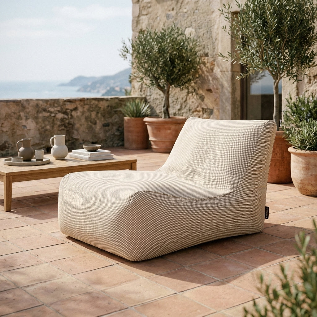 Beige sittsäck fåtölj Lounge 100 på en terrass med havsutsikt.