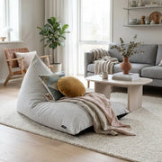 Sittsäck Razzmatazz Madu White displayed in a cozy, modern living room with a textured rug, throw blanket, and pillows.